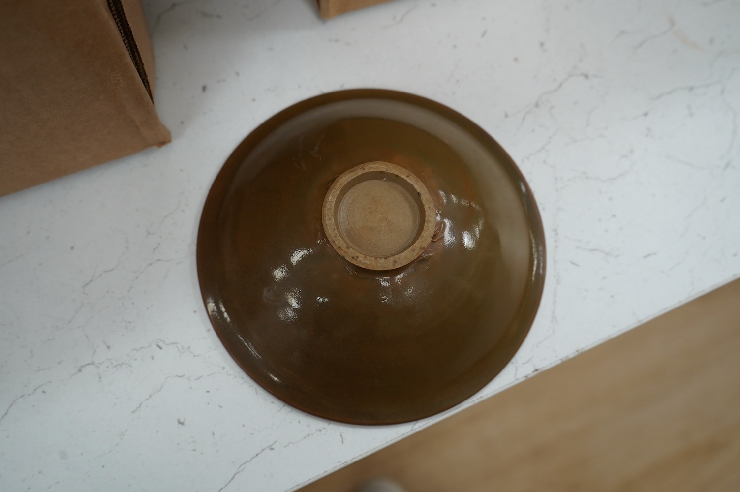 A Chinese Ding type brown glazed bowl with wooden case, 14cm in diameter. Condition - good